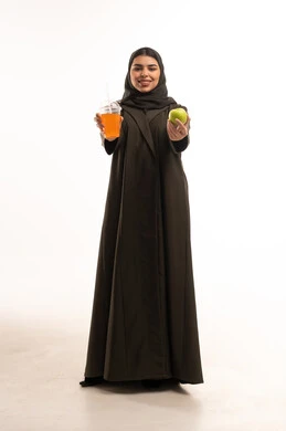 Emirati Woman Holding Green Apple and Orange Juice