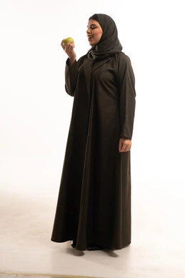 Saudi Woman in Abaya Holding Green Apple