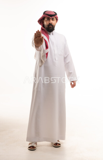 Saudi Man in Traditional Thobe Making Stop Hand Gesture