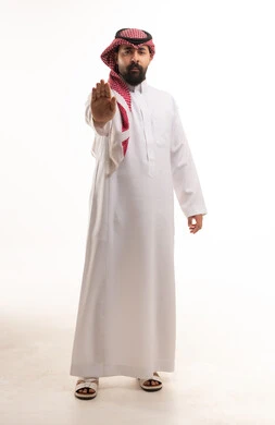 Saudi Man in Traditional Thobe Making Stop Hand Gesture