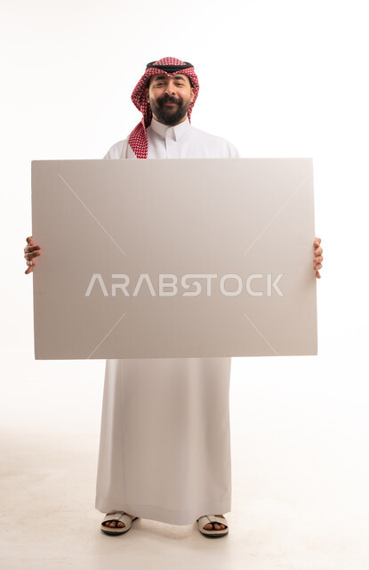 Saudi Man in Traditional Thobe Holding Blank Board