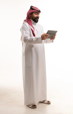 Saudi Man in Traditional Thobe Using Digital Tablet
