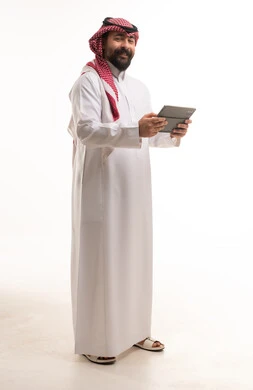 Saudi Man in Traditional Thobe Holding Digital Tablet