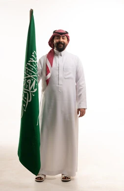 Saudi Man Holding National Flag on White Background