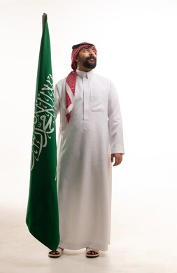 Saudi Man Holding Saudi Arabia Flag on White Background