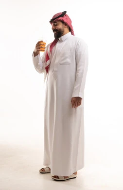 Saudi Man in Traditional Thobe Holding Juice
