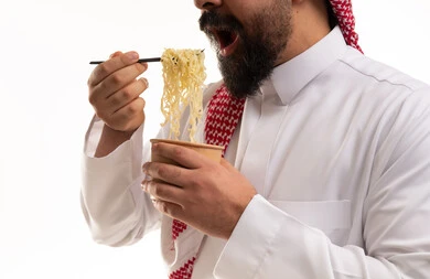 Saudi Man Eating Instant Noodles with Chopsticks