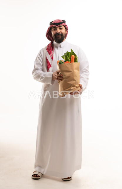 Saudi Man Holding Paper Bag of Fresh Vegetables