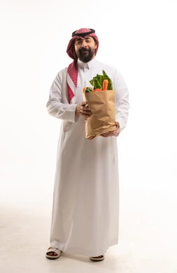 Saudi Man Holding Paper Bag of Fresh Vegetables