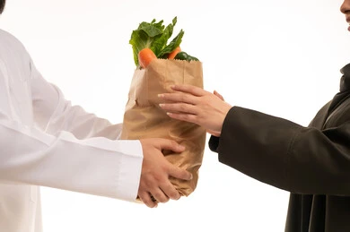 Saudi Man Giving Grocery Bag to Emirati Woman