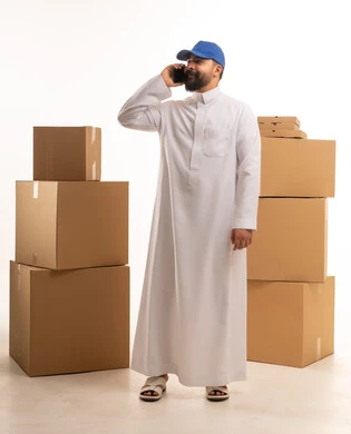 Saudi Man Talking on Phone Near Delivery Boxes