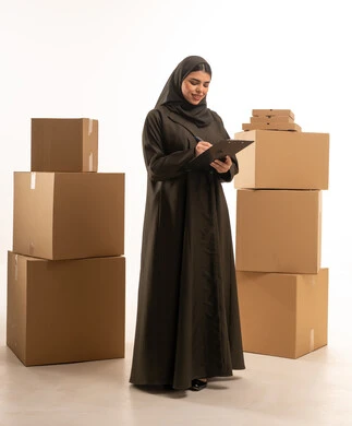 Saudi Woman with Clipboard and Shipping Boxes