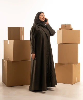 Saudi Woman with Moving Boxes on Smartphone