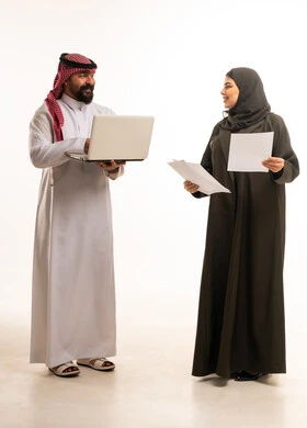 Saudi Business Colleagues With Laptop and Documents