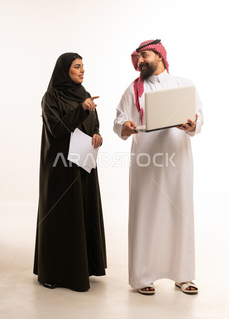Saudi Professional Colleagues with Laptop and Documents