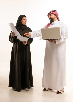 Saudi Business Colleagues with Laptop and Papers