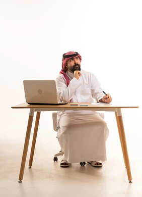 Thinking Saudi Man with Laptop on White Background