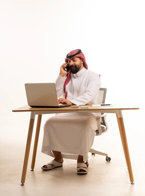 Saudi Businessman Working on Laptop in Modern Office