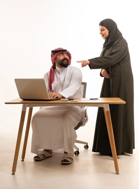 Saudi Man and Woman Working on Laptop in Office