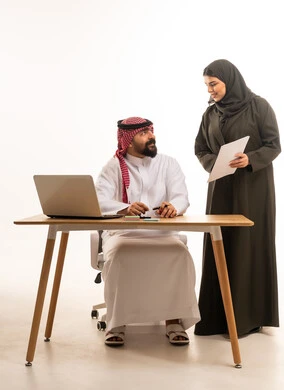 Saudi Business Colleagues Discussing Document in Office