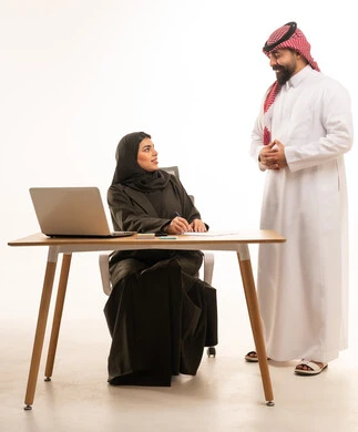 Saudi Business Colleagues Working at Office Desk