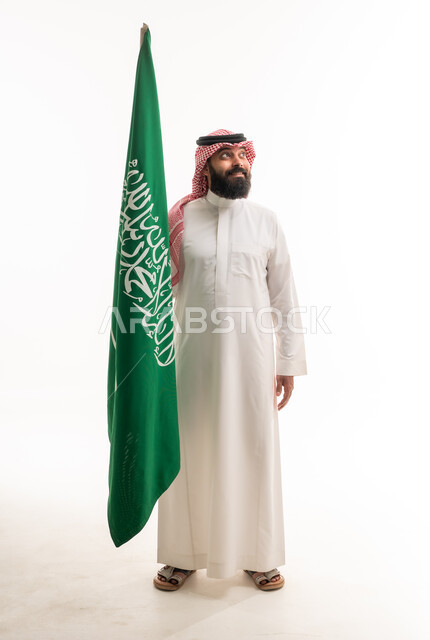 Saudi Man in Traditional Thobe Holding National Flag