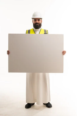 Saudi Engineer in Safety Gear Holding Blank Sign Board