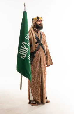 Saudi Man in Traditional Ardah Dress with Flag