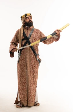 رجل سعودي بالزي التقليدي يمسك سيفاً