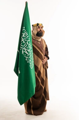Saudi Arabian Man in Traditional Bisht Holding National Flag