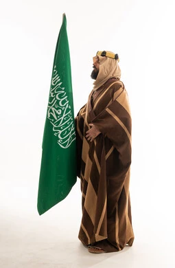Saudi Man in Traditional Bisht Holding Saudi Arabia Flag
