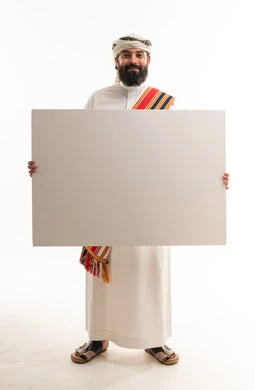 Omani Man in Traditional Dress Holding Blank Sign