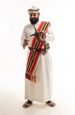 Omani Man in Traditional Dress with Coffee Dallah