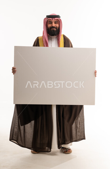 Saudi Man in Traditional Bisht Holding Blank Board