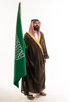 Saudi Man in Traditional Bisht with National Flag