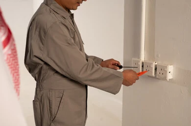 Technician Repairing White Electrical Wall Socket Indoor