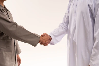 Arab Man and Industrial Worker Shaking Hands