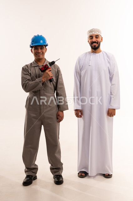 Omani Man and Asian Technician with Power Drill