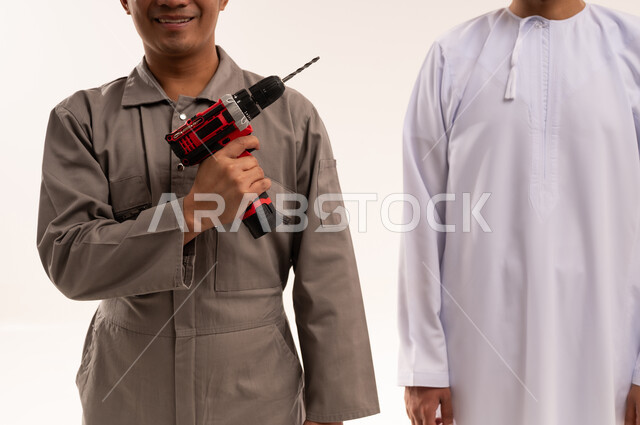 Emirati Man and Technician with Power Drill