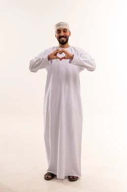 Omani Man in Traditional Dress Making Heart Gesture