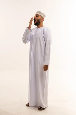 Omani Man in Traditional Dishdasha Yawning in Studio