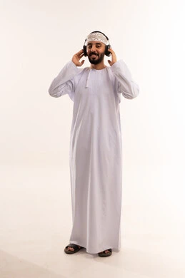 Omani Man in Traditional Dress Wearing Headphones