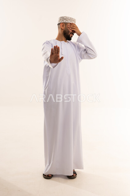 Omani Man in Traditional Dress Making Stop Gesture