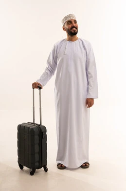 Omani Man in Traditional Dress with Suitcase
