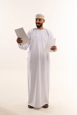 Omani Businessman in Traditional Dress Holding Documents