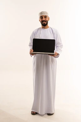 Omani Man in Traditional Dress Holding Laptop Computer