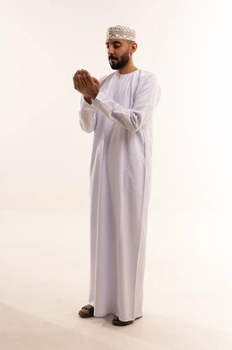 رجل عماني يدعو بالزي التقليدي العماني