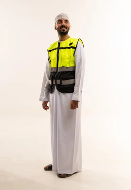 Omani Man in Traditional Dishdasha and Safety Vest