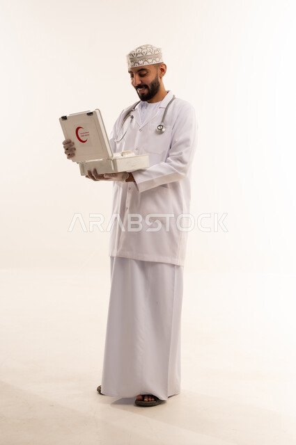 Omani Male Doctor Holding First Aid Kit in Studio