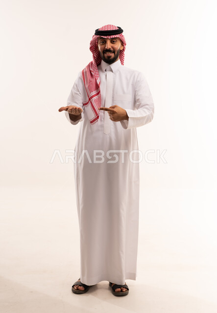 Saudi Man in Thobe Pointing at Palm White Background